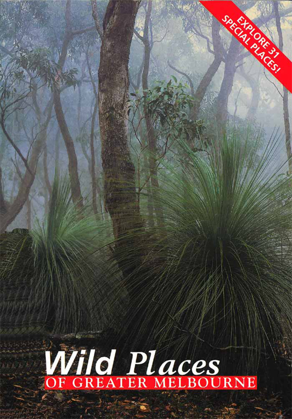 The cover image of Wild Places of Greater Melbourne, featuring a view of misty bush land, with spiky short green plants next to tall gum trees.
